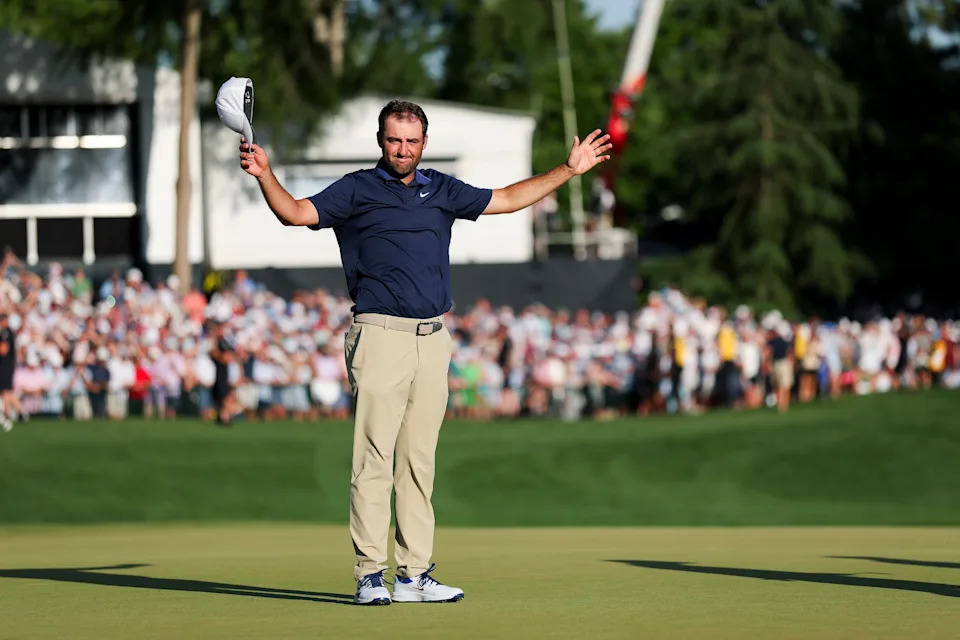Scottie Scheffler celebrates with his caddie Ted Scott after PGA Championship win